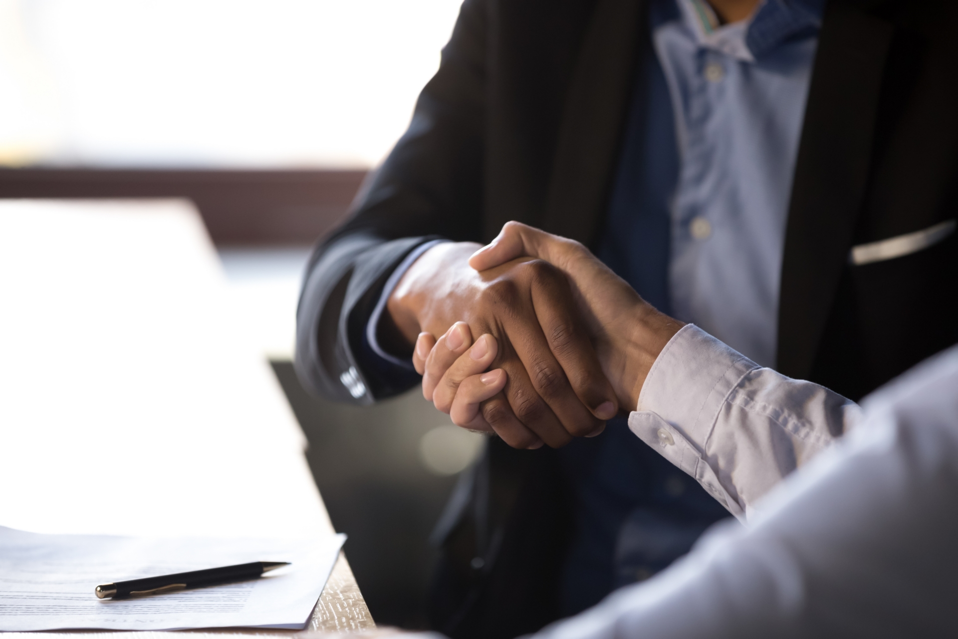 Close,Up,African,American,Businessman,Shaking,Hands,With,Caucasian,Client